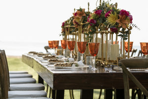 Elegant dinner table set before party and adorned by elegant floral centerpieces. Cover photo for the corporate collection.