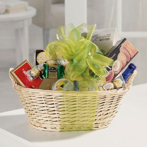 Ribbon-topped weaved gift basket filled with savory selection of candies, crackers, sparkling water, chocolates, and more