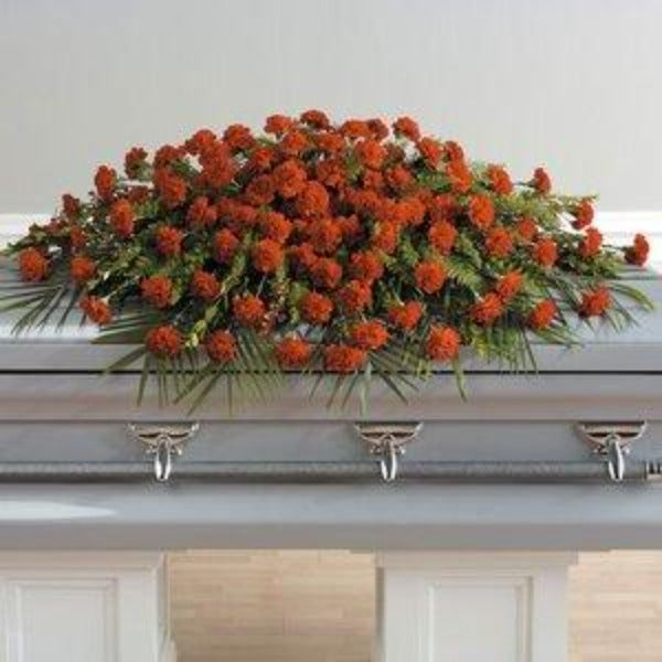Orange carnation casket floral arrangement